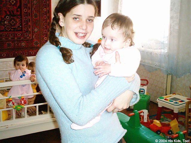 This little girl enjoys being held.