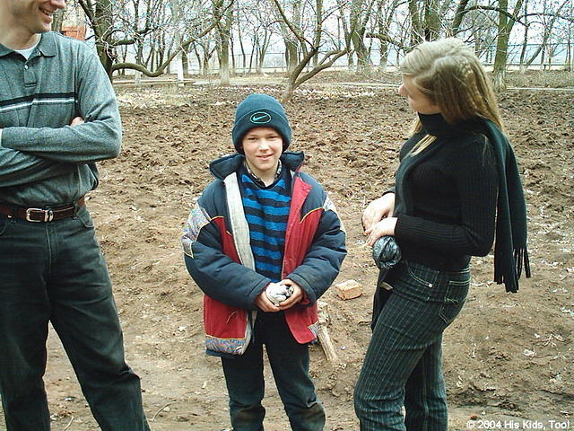 His Kids, Too! board member, Ray, and volunteer Christina speak with Victor.