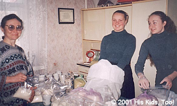 These three church member prepare food baskets for widows.