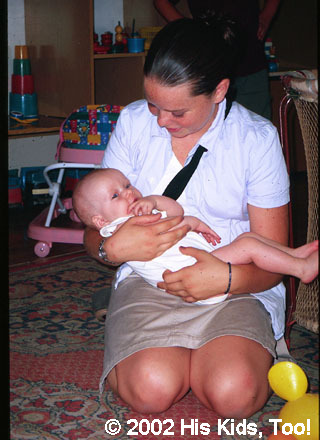 His Kids, Too! Volunteer, Lydia enjoys giving this baby some special attention