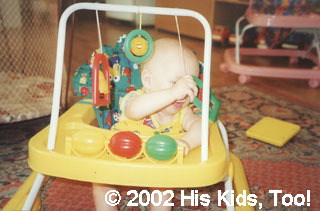 This baby enjoys the new walker, thanks to your donations!