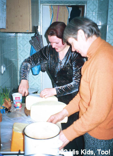 Ladies cut cheese portions for food bags