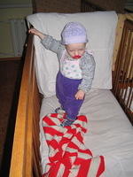 This baby isn't sure what to make of his new colorful blanket.