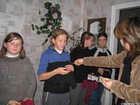 Fami passes out hair clips to the young teens.  Many are wearing clothes from our earlier in the week visit.