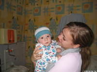 Kristina loves to hold the babies, and this one is wearing is new sleeper, and hat!