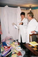 The assistant director reviews the donations with the inventory clerk.
