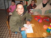 This young boy takes pride in his needlepoint.