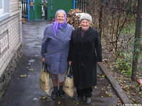 Two of the sisters who receive food bags.