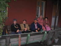 Several residents sit outside visiting.