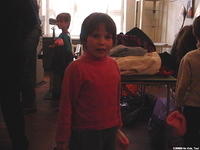 This little girl awaits her turn for clothing.