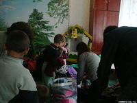 His Kids, Too! volunteers look through aide for clothing for each child.
