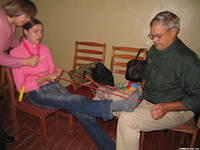 Walter Lee works with Yulia on an exercise that could help her achilles tendon.