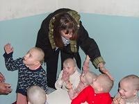 Peggy makes a point  of touching as many children as possible.