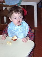 This little one enjoys his apple.