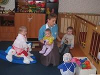 The workers enjoy playing with the kids.