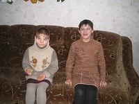 These young girls were so proud of the new sofa in the T.V. room.