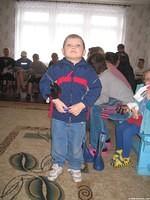 This boy was happy with his new clothes and coat.
