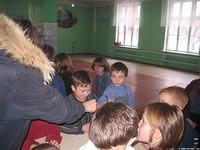 Kids receive parts of the Easter craft.