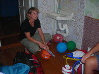 Karen prepares sports equipment for the next day deliveries.