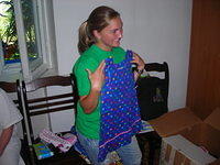 Jenn holds up one of the dresses.