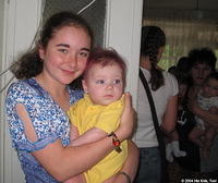 Dasha enjoys holding this child.