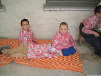 Children were everywhere at this facility.  Here some are resting in the shade of the covered porch.