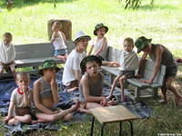 Groups of children were in the grass without underwear or shorts/pants.  Many were eating grass, or picking at one another.