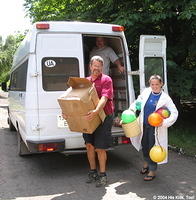 Here, His Kids, Too! board member,  Rich Fillmon, and volunteer Lydia, carry much needed supplies to the facility.