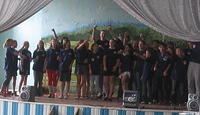 Andrew and Karen's class sing a group song.
