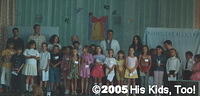Ms. Mae, Danny, and Haley's class  sing to the crowd of 200+.