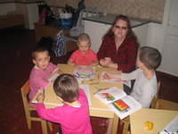 The younger kids look at their Bibles for the story.  Even the teacher enjoys the lesson.