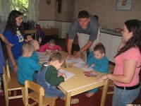 Haley, Lydia, and Danny W., assist with the crafts.