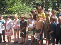 Children patiently wait their turn for choosing garments.