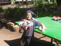 This boy just could not hold any more, so he set it on the ping pong table.