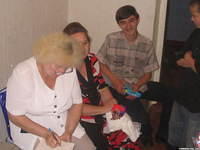 As children receive new clothing, staff member writes down each item for the inventory.