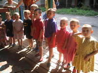 The smallest children wait patiently for clothing.