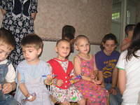 The children look at all the gifts.