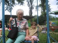 Mae L. of Florida, enjoys swinging with this little boy.