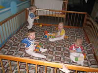 The children play in these large indoor playpens.