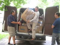 Volunteers unload boxes of aide for this facility.