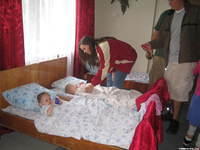 Lydia distributes toys to ALL the children.
