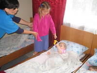 Alla, hands this little girl a new toy.