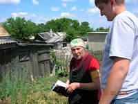 Vanya gives one of the program clients a Bible.