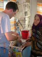 The lady offered Dave some fruit.
