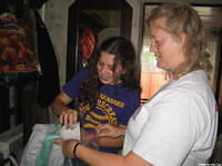 Kristy and Haley seperate sugar into ziplock bags.
