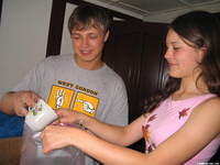 Two local teens volunteer to help, by separating rice into bags.