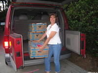 Volunteer Nancy S. helps unload boxes.