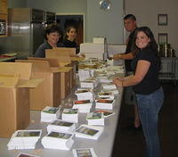 Ginny W. and volunteers, sort and collate cards made by orphans, for sale in the His Kids, Too! Gift Shop!