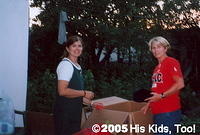 Summer 2005, in Ukraine, Karen and Teresa sort massive amount of clothing, preparing for distribution.