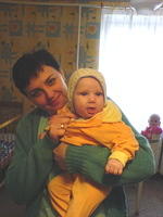This caring nurse lovingly shows off the baby in it's new clothes.  Thanks Neve and friends.